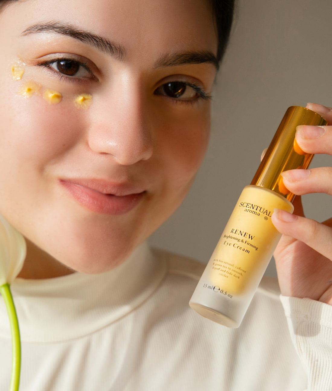 Renew Brightening & Firming Eye Cream applied under eyes from.Scentual Aroma